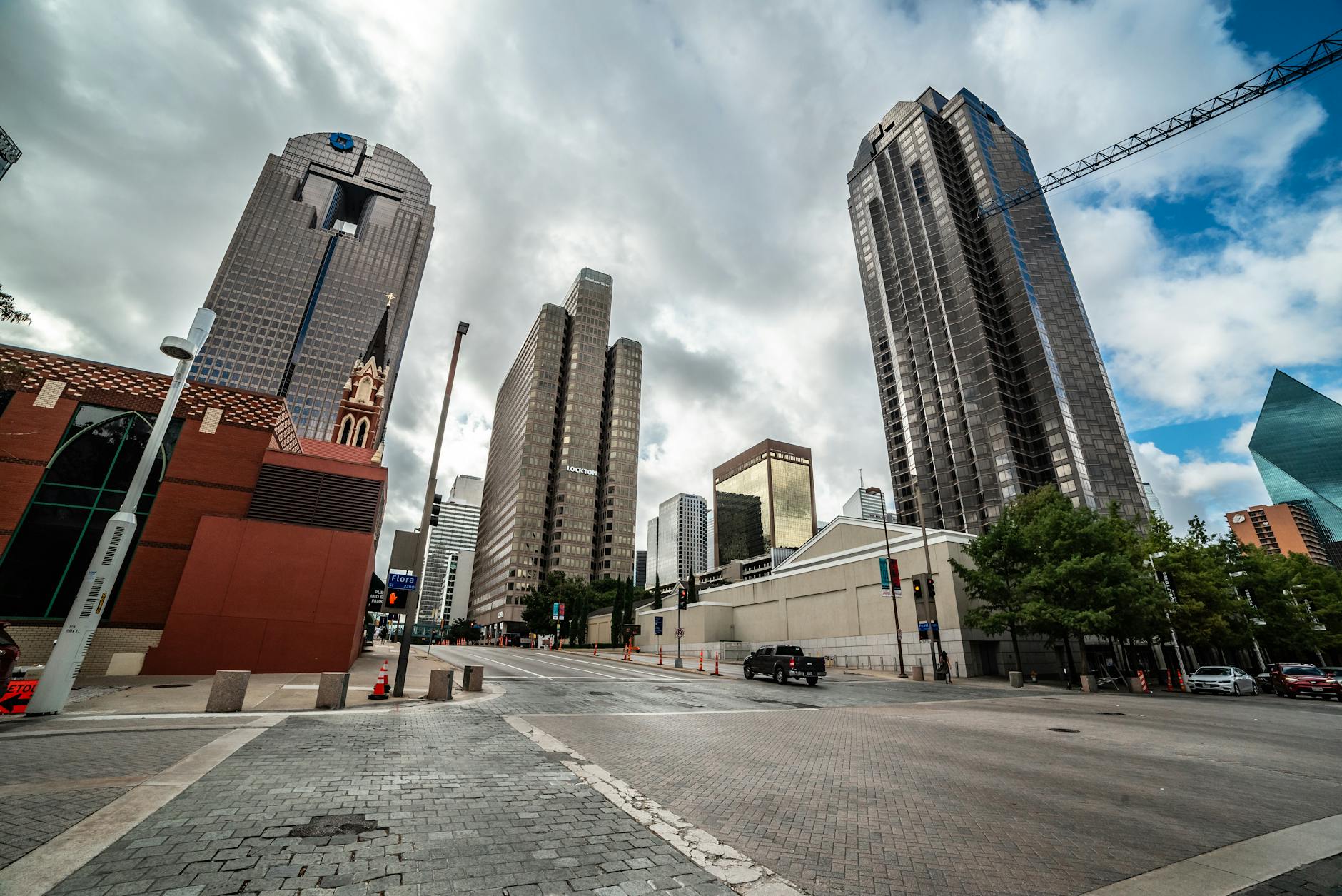 Explore the modern skyline of downtown Dallas, Texas with towering skyscrapers under a dramatic sky.